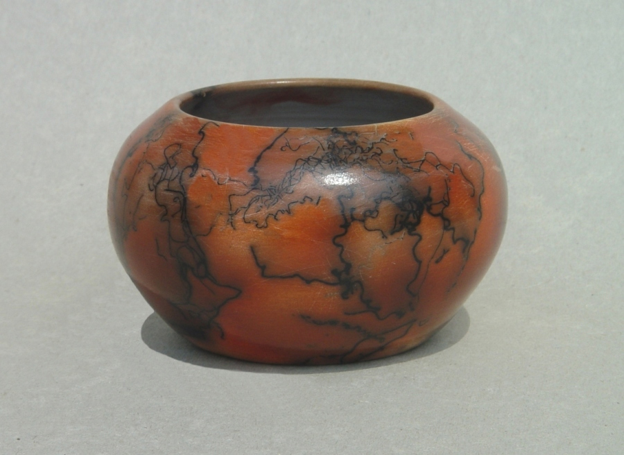 Horse Hair Raku Bowl: Porcelain with terra sigillata, colored with ferric chloride